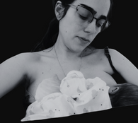 postpartum image of a mother with a baby breastfeeding